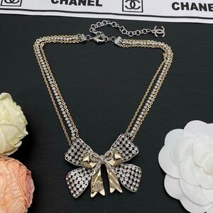 Elegant CHANEL Crystal Bow Necklace in Gold and Silver